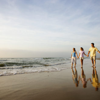 Family walking along beach