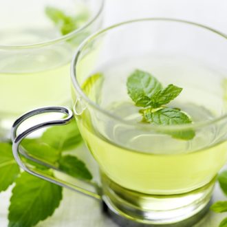 cup of mint tea with leaves