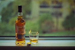 Bottle of whisky and glass