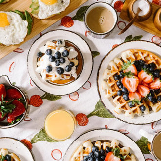 pancakes and waffles on table with fruit