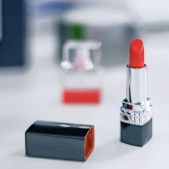 red lipstick tube open on table