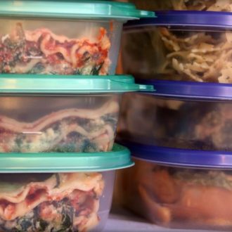 meal prep food in containers in freezer