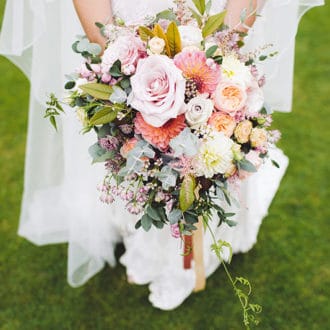 bride holding wedding bouquet of flowers