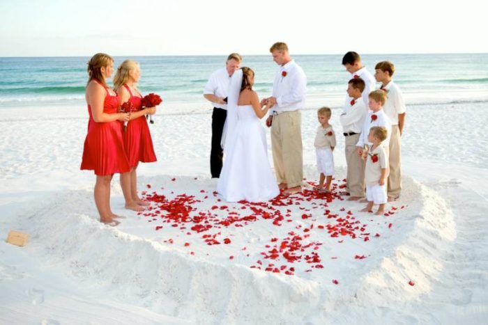 Small beach wedding ceremony with bride and groom