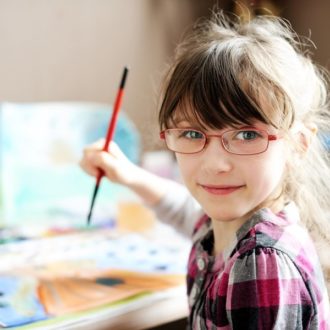 young girl with glasses at desk