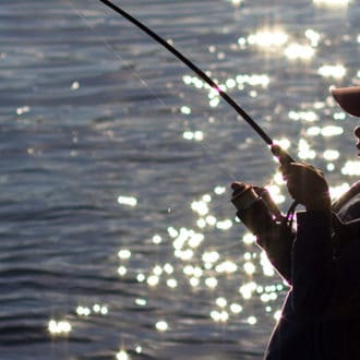 Young boy fishing in lake