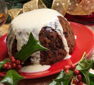 Christmas Pudding with custard and berries