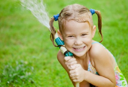 girl holding garden hose