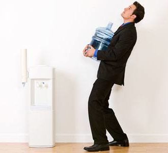 Man carrying heavy water cooler