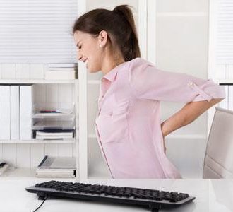 Woman at office with sore lower back