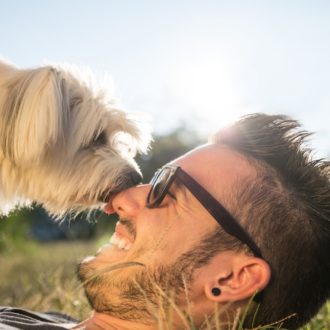 man laying down happy with dog