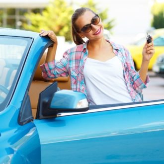 Young woman with blue car