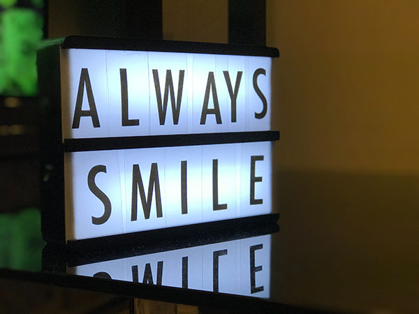 Neon sign that says always smile