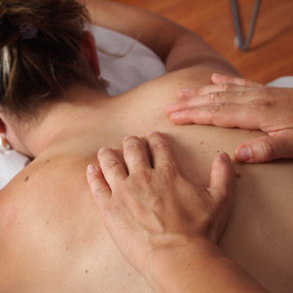 hands massaging womans back