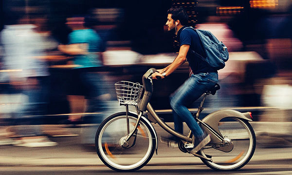 Man riding bike through city