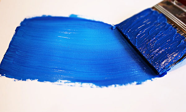 Blue paint and paintbrush