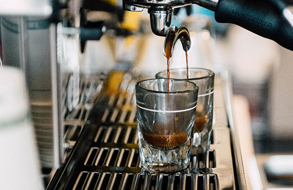 espresso shots being poured by coffee machine