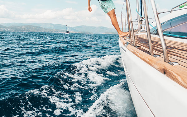 Man standing on side of yacht