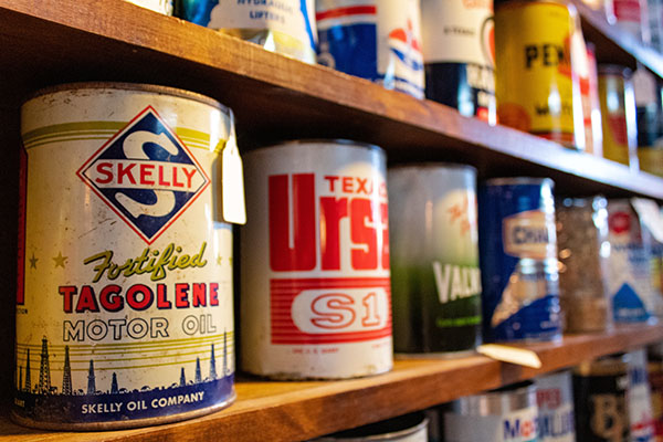 retro style motor oil tins on shelf