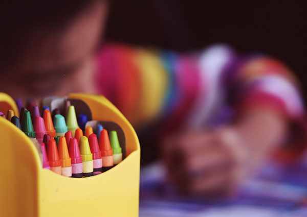 Boy drawing with crayons
