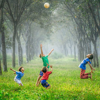 Kids jumping and playing with ball