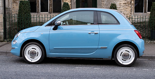 small blue car on road