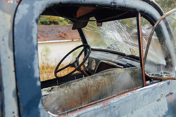 Old blue volkswagen car with broken windscreen