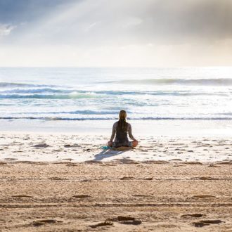 Holistic health can include meditation on the beach