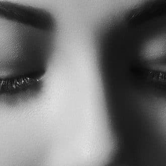 Black and white image of woman with eyelash extensions