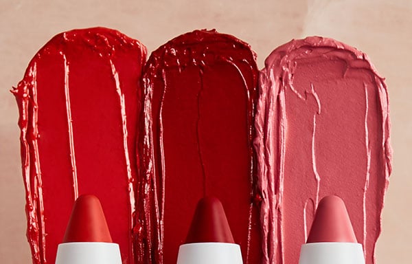 three swatches of red and pink lipstick