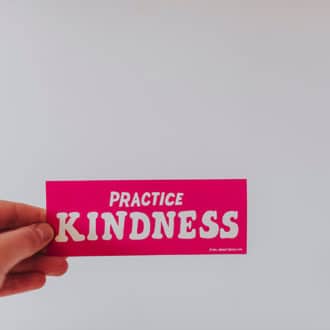 pink sticker that says practice kindness