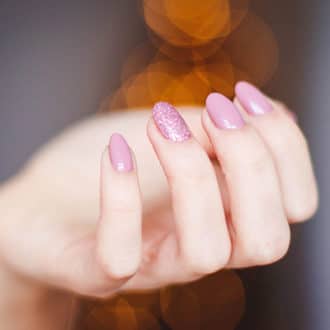 pink nail polish manciured hand