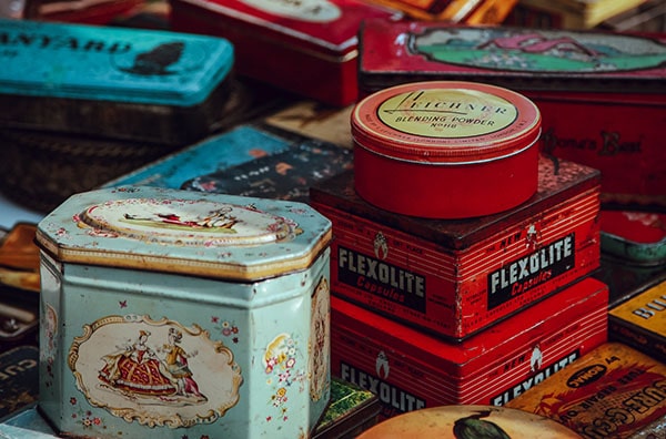 piles of assorted red and blue vintage steel tins