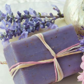 bar of purple lavender soap with flowers and lavender