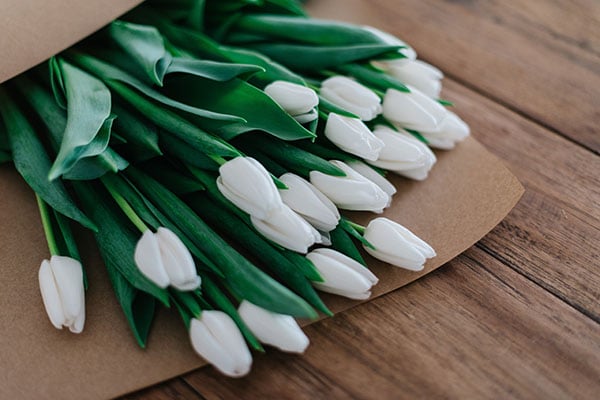 floral paper bouquet with white tulips laying on desk