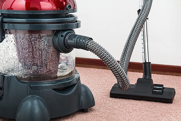 black and red vacuum cleaner on red carpet