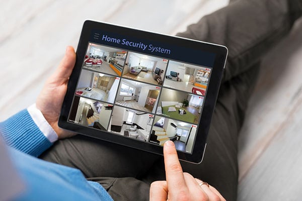 tablet device with home security cameras feed monitor