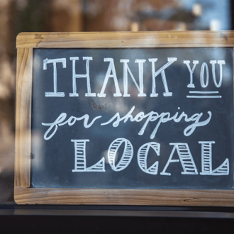 Thank you for shopping local sign in store window