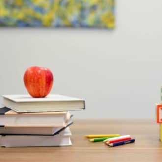 Teacher with apple on desk