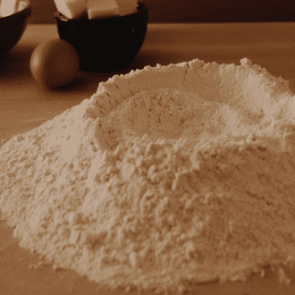 Flour on a wood kitchen table in a