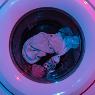 Washing machine in blue and purple lighting