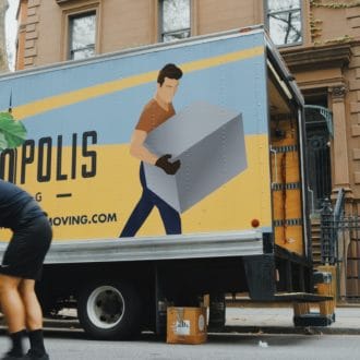 Movers in NYC moving a large plant